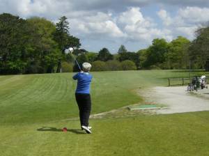 A member of the winning ladies' team tees off on the first